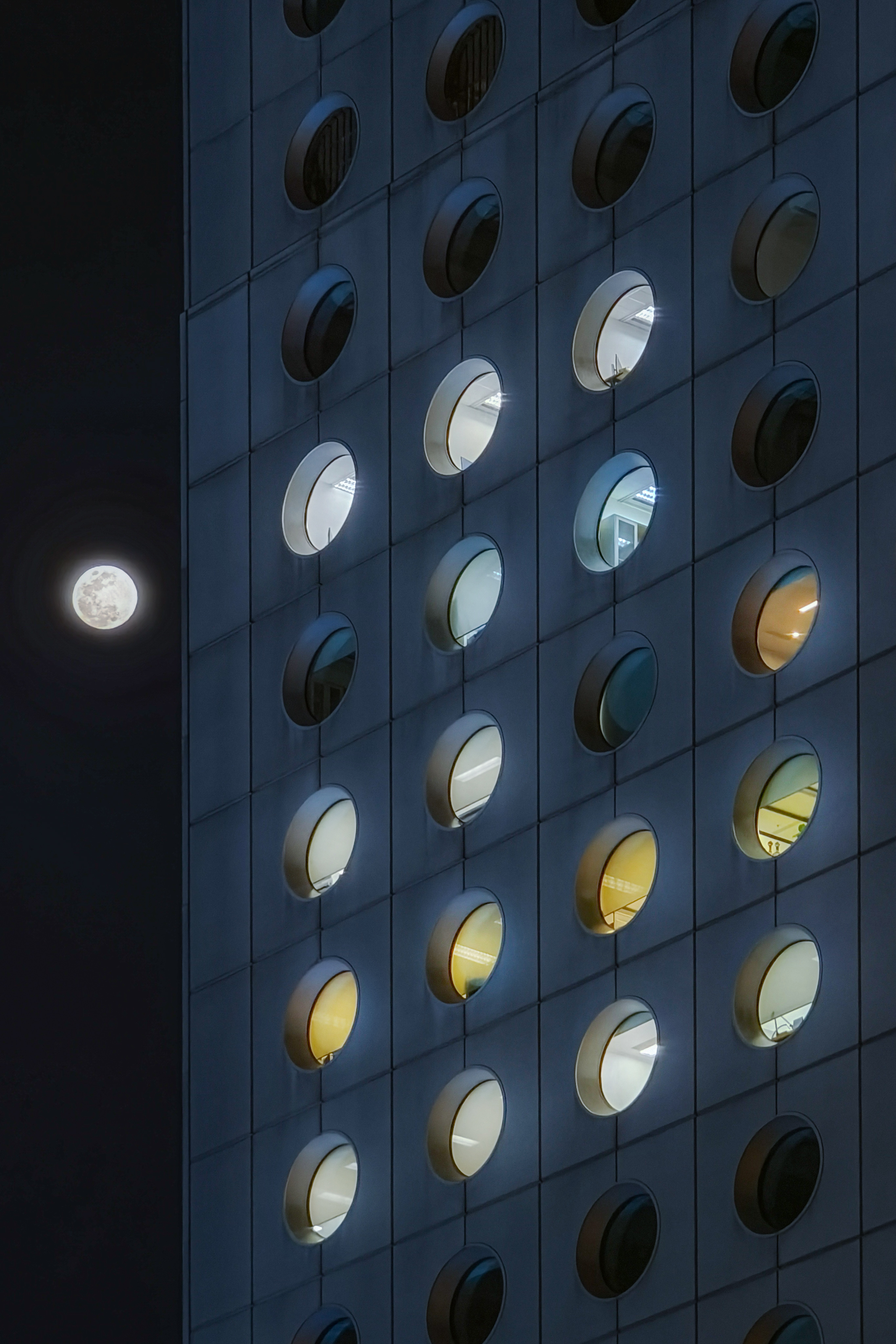 Jardine House night façade beside the moon